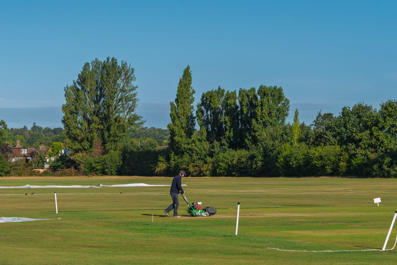 Professional groundskeeper maintaining a large landscaped property